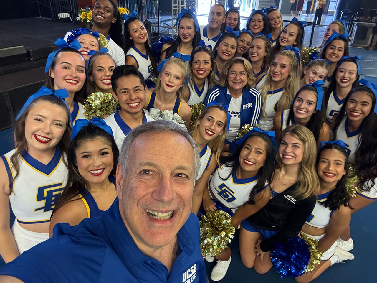 Chancellor Assanis with UCSB cheerleaders.